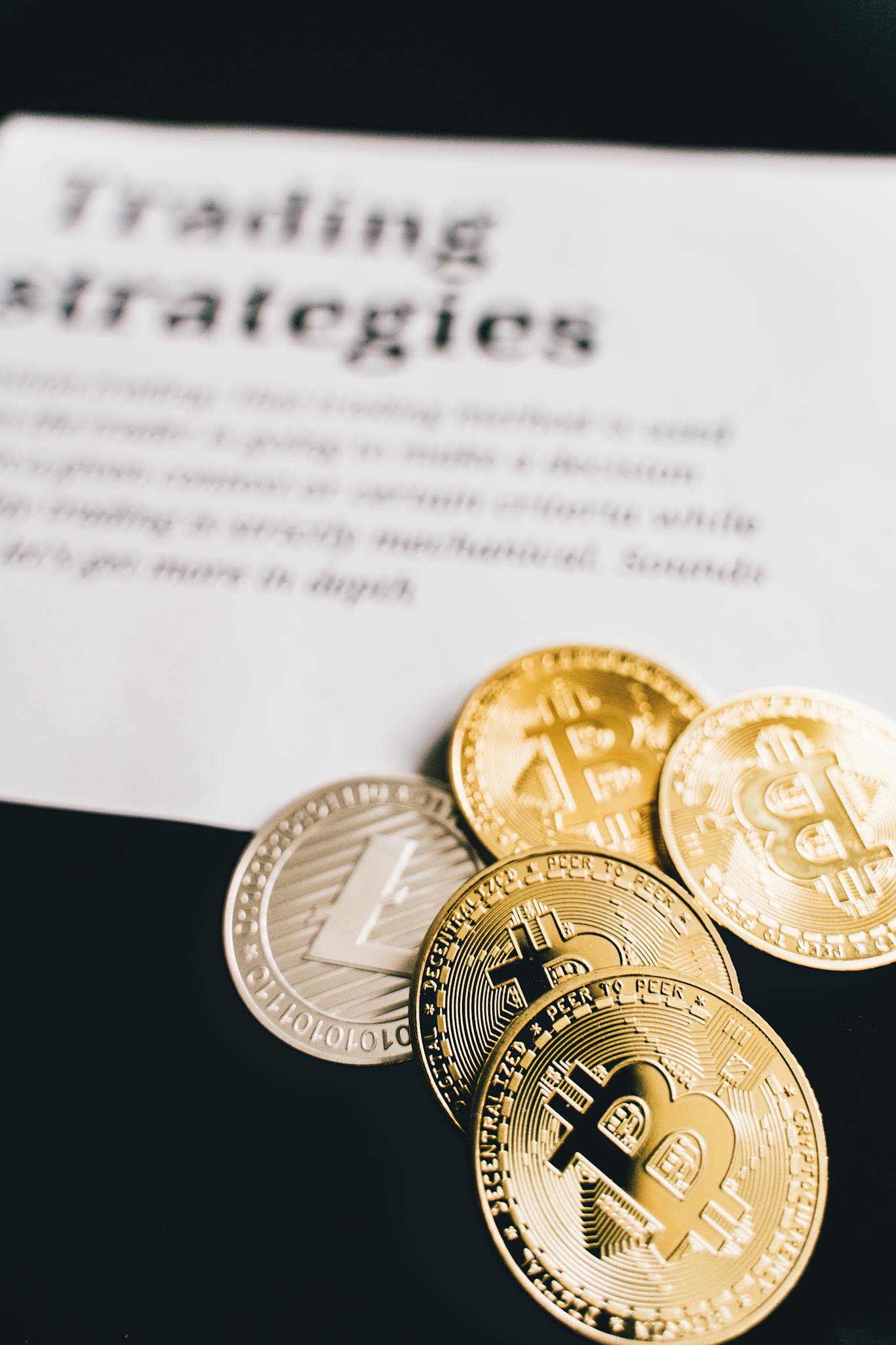 Home - Mundo Crypto Close-up of Bitcoin and Litecoin coins on a trading strategies document.
